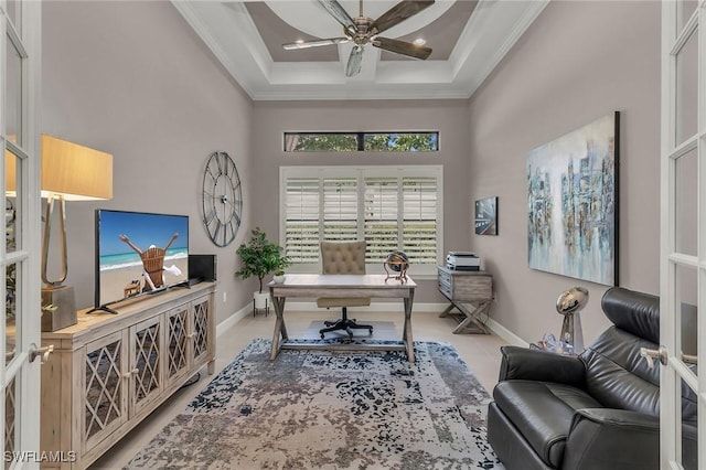 office featuring ceiling fan, a high ceiling, baseboards, and crown molding