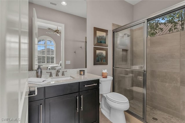 full bath with toilet, a stall shower, visible vents, and vanity