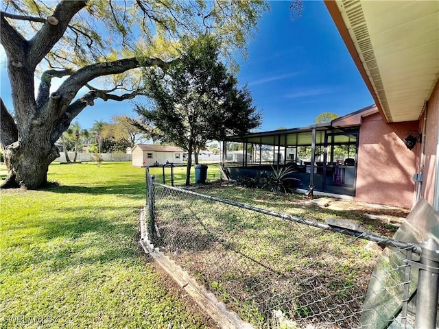 view of yard with a sunroom and fence