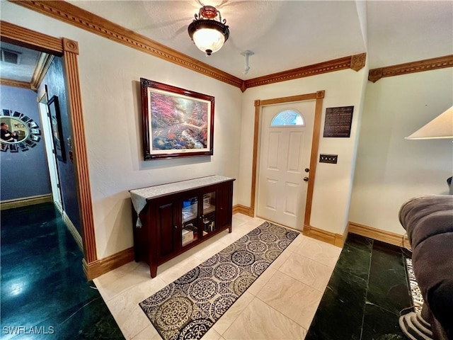 foyer featuring ornamental molding and baseboards