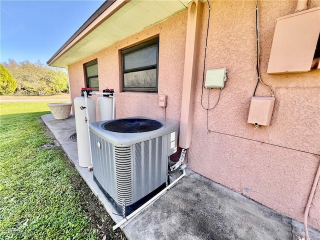 exterior details with central AC unit and stucco siding