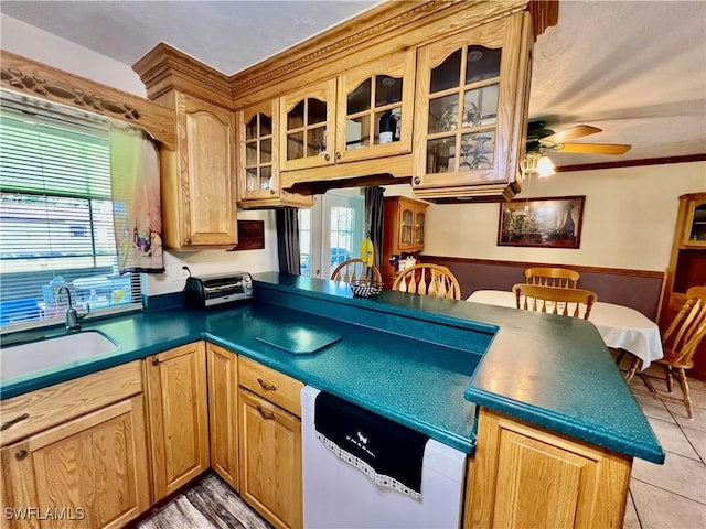 kitchen with a wealth of natural light, a sink, dishwasher, and light tile patterned floors