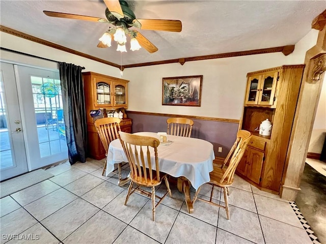 dining room featuring light tile patterned floors and ornamental molding