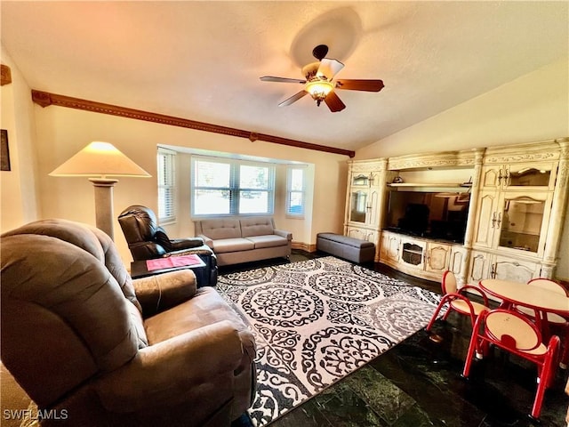 living room with lofted ceiling, ceiling fan, and baseboards