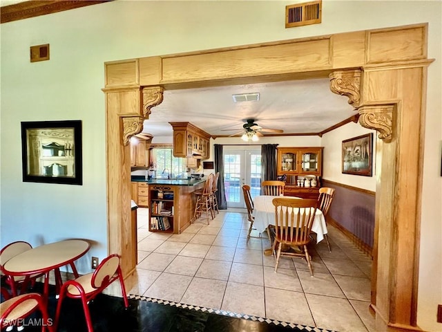 dining room featuring light tile patterned floors, french doors, ornamental molding, and visible vents