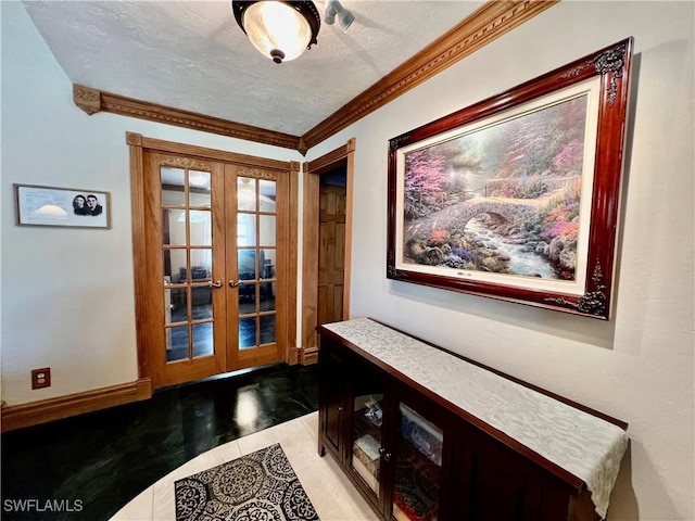 interior space with a textured ceiling, light tile patterned floors, baseboards, french doors, and ornamental molding