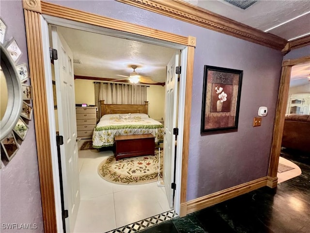 tiled bedroom featuring ornamental molding, visible vents, and baseboards