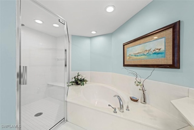 bathroom featuring a garden tub, recessed lighting, and a stall shower