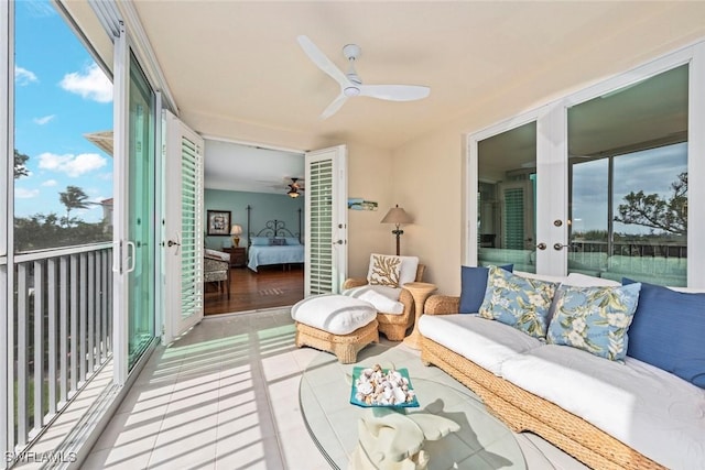 sunroom / solarium with a ceiling fan and french doors