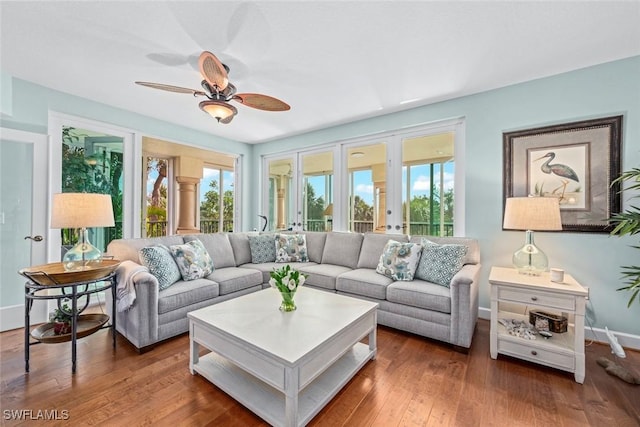 living area with ceiling fan, french doors, baseboards, and wood finished floors