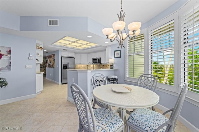 dining space featuring visible vents, baseboards, light tile patterned floors, recessed lighting, and a notable chandelier