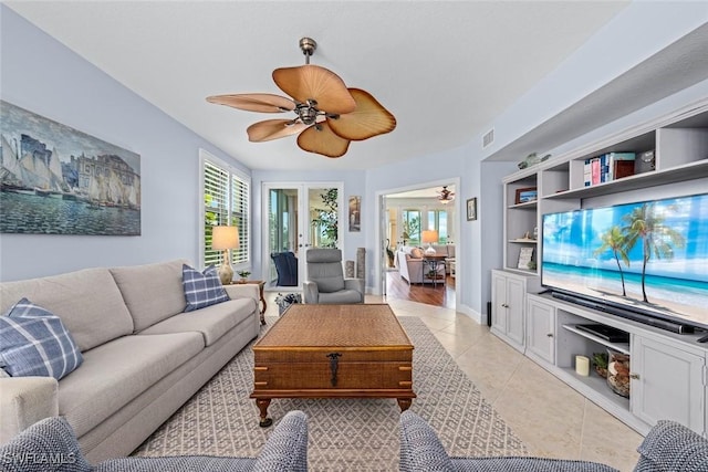 living area with visible vents, light tile patterned flooring, and a ceiling fan