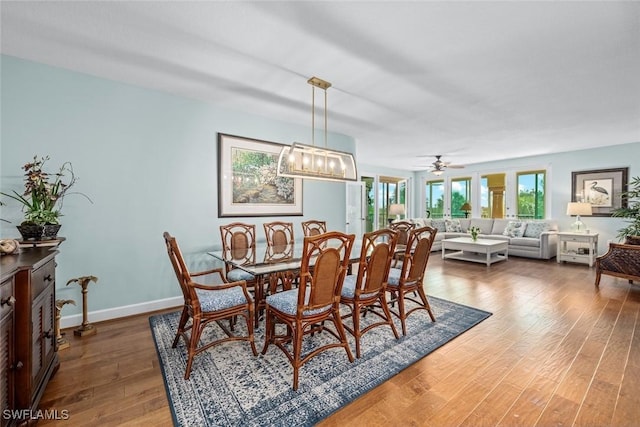 dining area featuring wood finished floors and baseboards