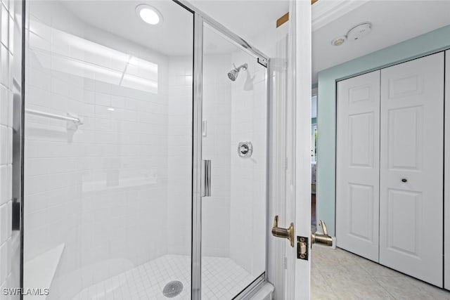 full bathroom featuring a stall shower and tile patterned flooring