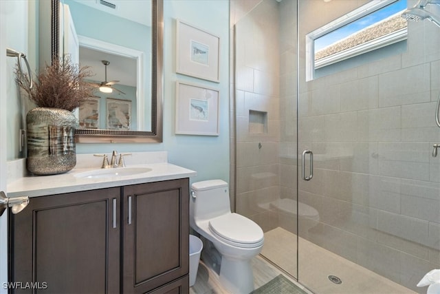 full bath featuring a stall shower, vanity, and toilet