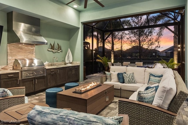 view of patio / terrace featuring an outdoor living space with a fire pit, glass enclosure, a grill, a sink, and exterior kitchen