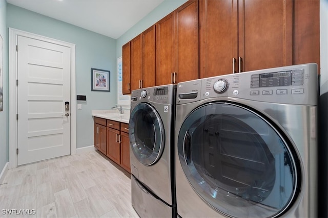 laundry room featuring baseboards, cabinet space, and washer and dryer