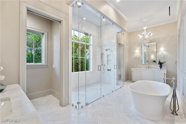 bathroom with crown molding, a soaking tub, vanity, a shower stall, and a chandelier