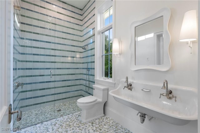 bathroom featuring a shower stall and toilet