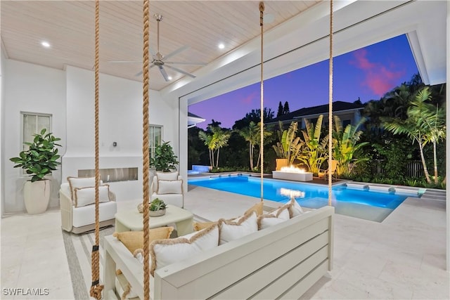 view of swimming pool with a fenced in pool and ceiling fan