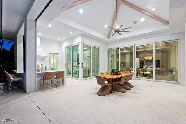 sunroom / solarium with lofted ceiling with beams, ceiling fan, and french doors