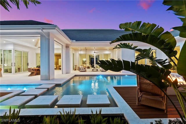 exterior space featuring a patio area, an outdoor pool, and a ceiling fan