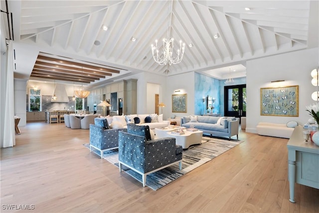 living area with high vaulted ceiling, light wood-style floors, beam ceiling, and an inviting chandelier