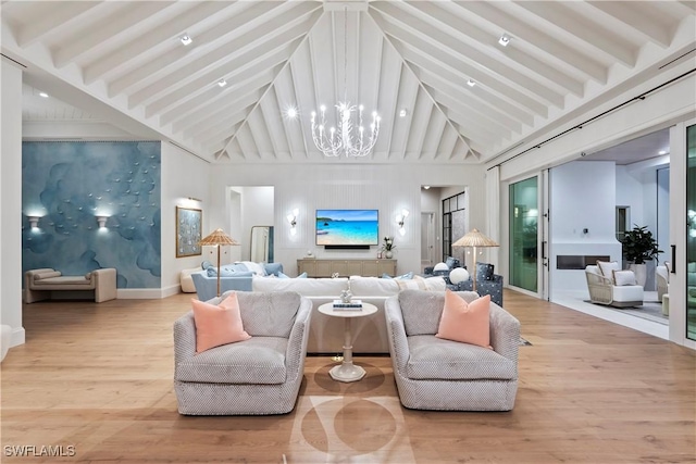 living room featuring beam ceiling, high vaulted ceiling, a notable chandelier, and wood finished floors