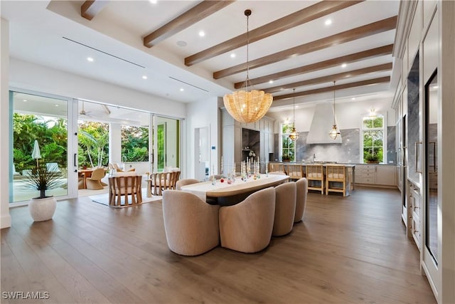 living room featuring hardwood / wood-style flooring, recessed lighting, beamed ceiling, and french doors