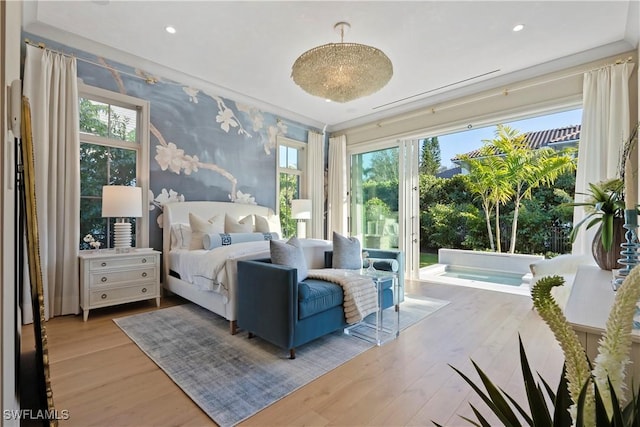 bedroom with access to outside, wood finished floors, and recessed lighting