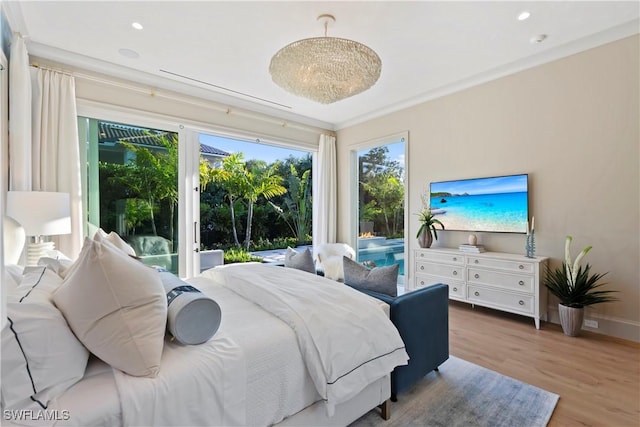 bedroom featuring access to exterior, baseboards, wood finished floors, and recessed lighting