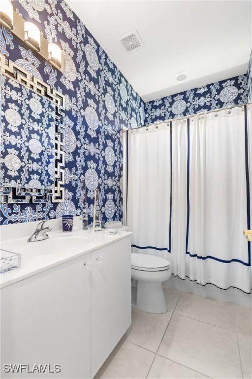 bathroom featuring tile patterned flooring, visible vents, wallpapered walls, toilet, and vanity