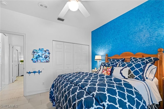 bedroom featuring tile patterned flooring, visible vents, baseboards, ceiling fan, and a closet