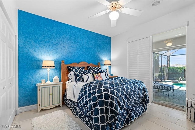 bedroom with access to exterior, an accent wall, baseboards, a sunroom, and a ceiling fan