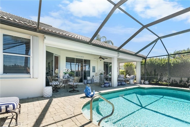 pool with a patio, outdoor dining area, a lanai, and ceiling fan