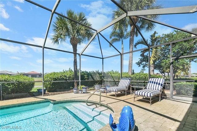 outdoor pool with a lanai and a patio area