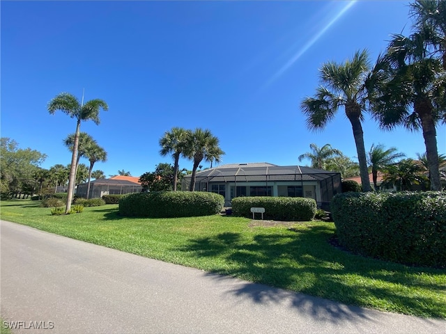 view of front of property with a lanai and a front lawn