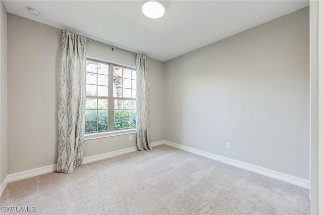 empty room with carpet and baseboards