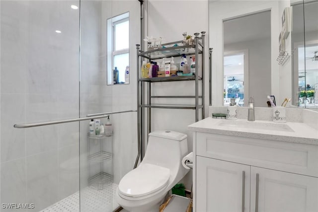 bathroom featuring a stall shower, vanity, and toilet