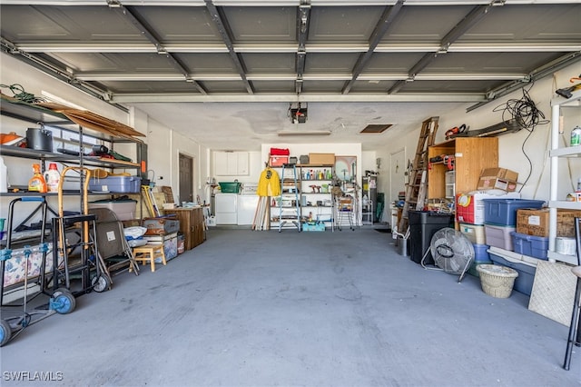 garage featuring a garage door opener and washing machine and dryer