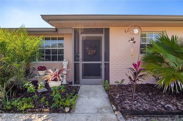 entrance to property with brick siding