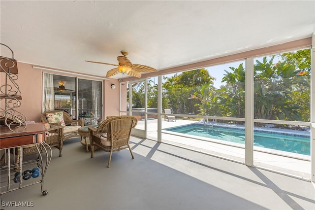 sunroom / solarium with a ceiling fan