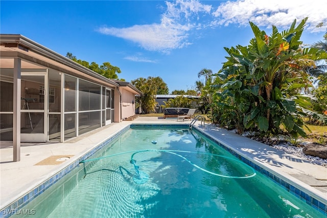 outdoor pool featuring a patio and a sunroom