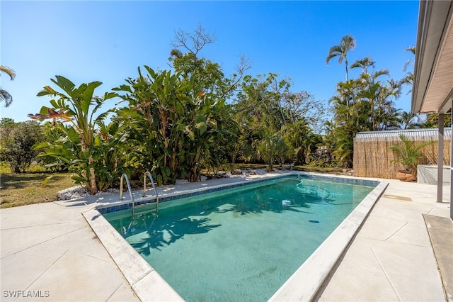 view of pool with a patio area, fence, and a fenced in pool