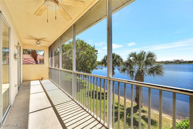 balcony featuring a water view and a ceiling fan