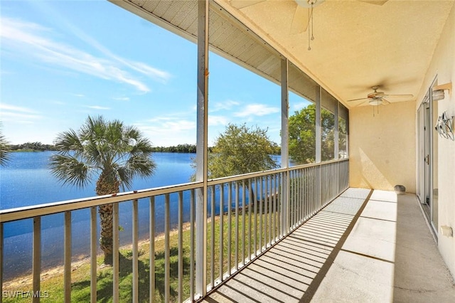 balcony with a water view and ceiling fan