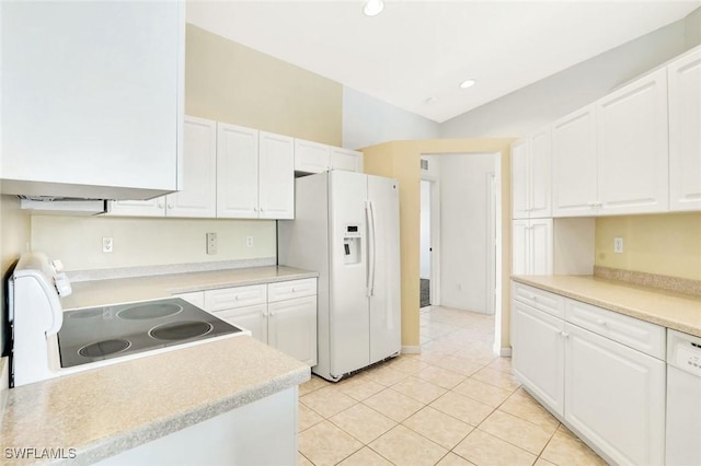 kitchen with light countertops, white appliances, white cabinets, and light tile patterned flooring