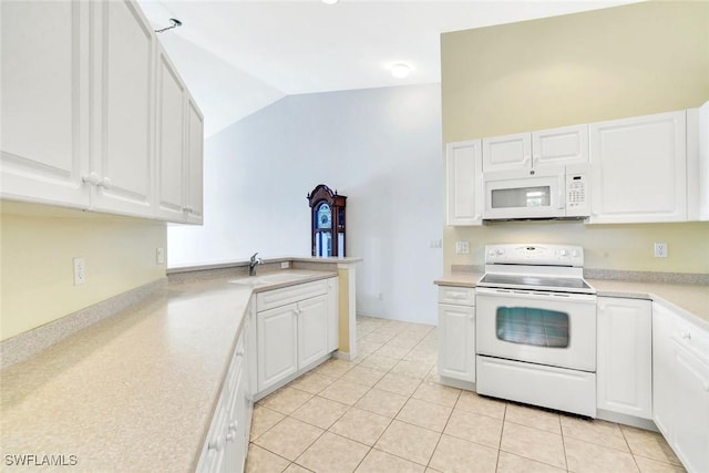 kitchen featuring lofted ceiling, light countertops, white cabinets, a sink, and white appliances