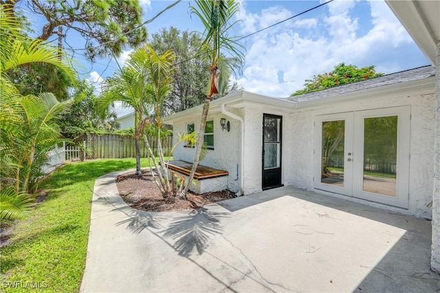 view of patio featuring french doors and fence