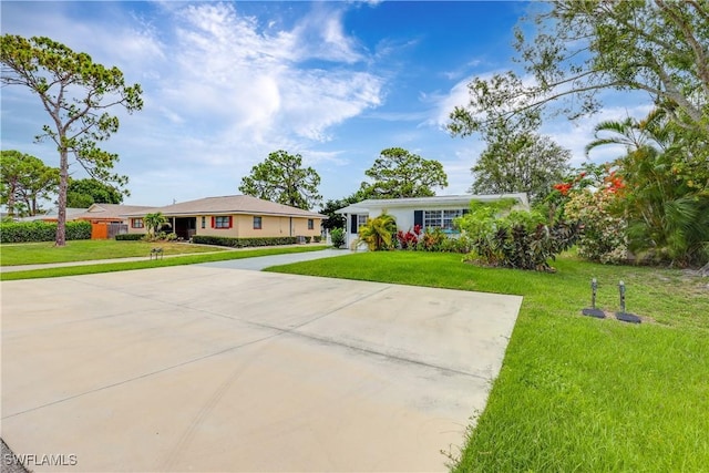 single story home with driveway and a front lawn